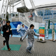 People participate at a missile evacuation drill at an amusement park near Tokyo Dome stadium in Tokyo.